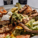 grilled chicken fajita sliced eggs tomatoes lettuce cheese guacamole