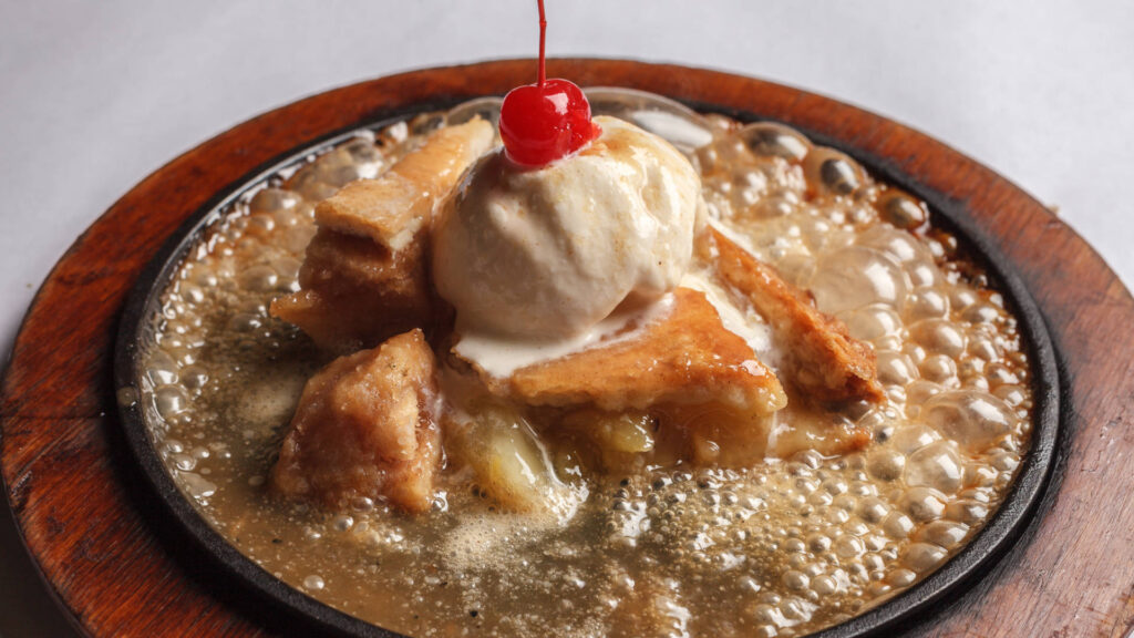 apple pie caramel sauce ice cream on top and a cherry