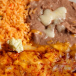 rice fried beens burrito with cheese on top