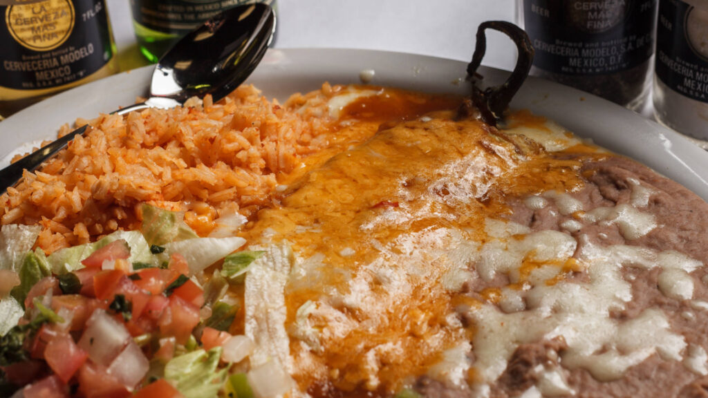 fried beans rice chille relleno pico de gallo cheese on top of the beans