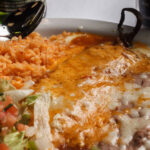 fried beans rice chille relleno pico de gallo cheese on top of the beans