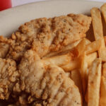 breaded fried chicken strips with fries