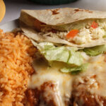 enchilada soft taco chile relleno lettuce tomatoes refried beens rice cheese on top