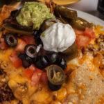 nachos ground beef melted cheese black olives jalapenos pico de gallo saur cream
