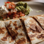 quesadilla sliced pico de gallo sour cream and guacamole